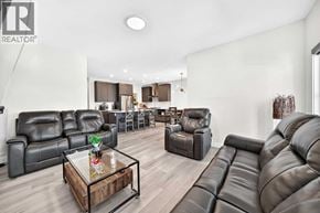 Calgary apartment for rent - A living room with black leather furniture and a glass coffee table.