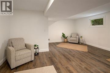 Point Edward apartment for rent - A living room with a chair and a couch.