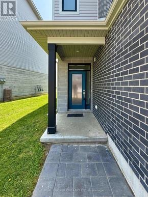 London East (East D) townhouse for rent - A house entrance with a blue door and a brick wall.