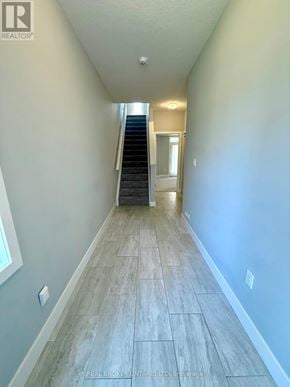 London East (East D) townhouse for rent - A hallway with a staircase and a door at the end.