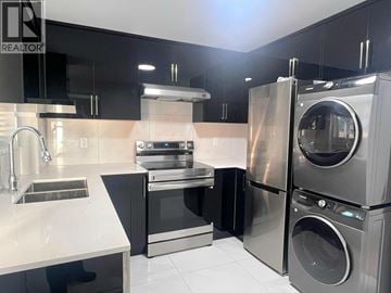 Vancouver apartment for rent - A modern kitchen with a stainless steel refrigerator, oven, and dishwasher.