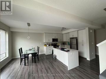 London North (North E) house for rent - A well-lit kitchen with a dining table and chairs.