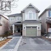 Ottawa apartment for rent - A house with a grey garage door is in front of a house with a brown garage door.