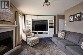 Ottawa apartment for rent - A living room with a fireplace and a grey couch.