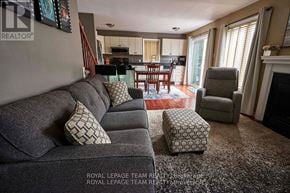 Ottawa apartment for rent - A living room with a grey couch and a fireplace.