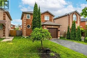 Barrie (Georgian Drive) apartment for rent - A house with a brown brick exterior and a tree in front of it.