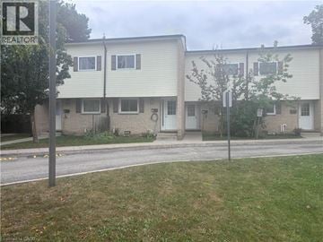 Kitchener townhouse for rent - A building with a sign that says REALTOR in front of it.