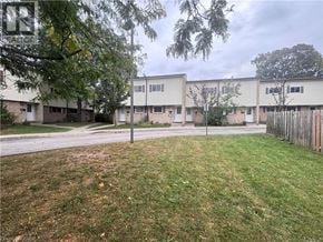 Kitchener townhouse for rent - A grassy area in front of apartment buildings.