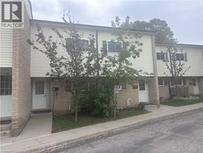 Kitchener townhouse for rent - A building with a sign that says REALTOR on it.