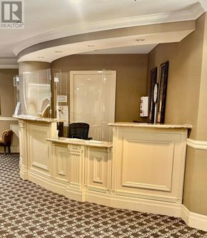 Mississauga (City Centre) condo for rent - A reception area with a desk and a chair.