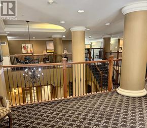 Mississauga (City Centre) condo for rent - A large room with a staircase and a chandelier.