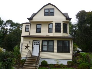 West Orange apartment for rent - A two story house with a white door and a star above it.