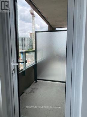 Toronto (South Parkdale) condo for rent - A view from inside a room looking out through a glass door.