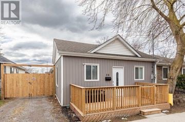 St. Catharines (E. Chester) apartment for rent - A small house with a grey roof and a wooden fence.