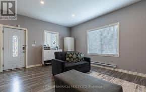 St. Catharines (E. Chester) apartment for rent - A living room with a couch, a chair, and a window.