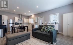 St. Catharines (E. Chester) apartment for rent - A modern kitchen with a dining table and a grey sofa.