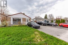 Brampton (Avondale) apartment for rent - A row of cars parked in front of a house.