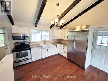 Georgina (Keswick North) apartment for rent - A kitchen with stainless steel appliances and wooden floors.
