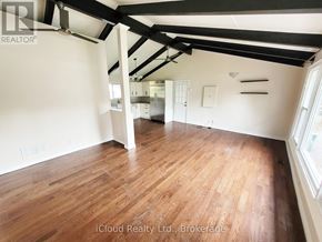 Georgina (Keswick North) apartment for rent - A room with wooden flooring and white walls.