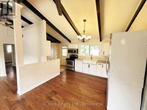 Georgina (Keswick North) apartment for rent - A large open kitchen and living room with wooden floors and white walls.