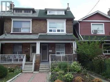 Toronto (Corso Italia-Davenport) apartment for rent - A house with a red roof and a sign that says REALTOR.
