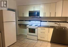 Toronto (Corso Italia-Davenport) apartment for rent - A kitchen with white cabinets and a white refrigerator.