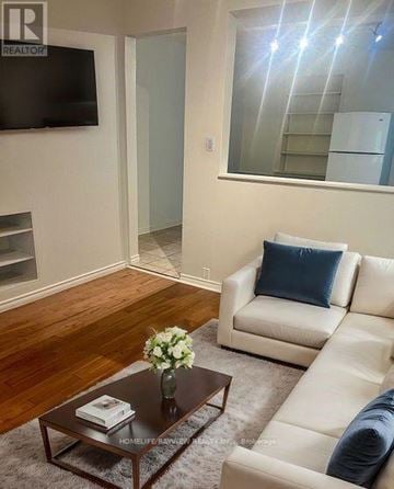 Toronto (Corso Italia-Davenport) apartment for rent - A living room with a white couch and a coffee table.