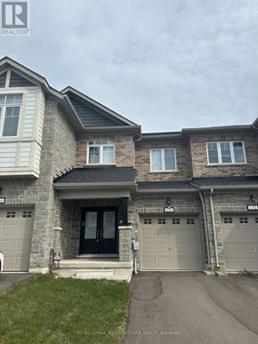 Thorold (Rolling Meadows) townhouse for rent - A house with a black front door and two garages.