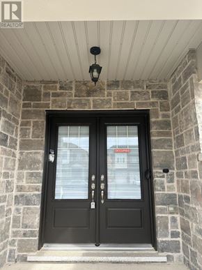 Thorold (Rolling Meadows) townhouse for rent - A black double door with a glass window and a sign that says "Occupied" on it.