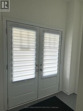Thorold (Rolling Meadows) townhouse for rent - A pair of white doors with blinds on them.