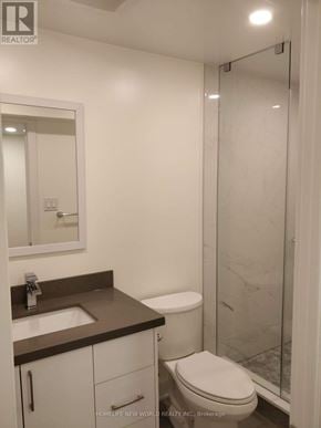 Toronto (Woodbine-Lumsden) apartment for rent - A bathroom with a toilet, sink, and mirror.