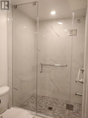 Toronto (Woodbine-Lumsden) apartment for rent - A white bathroom with a glass shower stall.