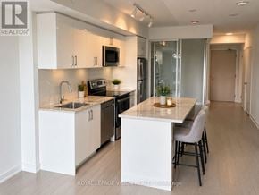 Toronto (Humber Heights) condo for rent - A modern kitchen with a dining table and chairs.