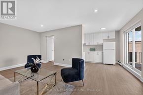 St. Catharines (Secord Woods) multi-family for rent - A living room with a glass table and two chairs.