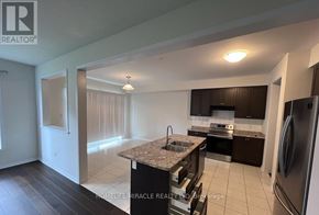 Niagara Falls (Brown) apartment for rent - A kitchen with a refrigerator, sink, and cabinets.
