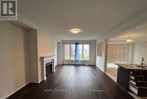 Niagara Falls (Brown) apartment for rent - A spacious living room with a fireplace and a kitchen area.