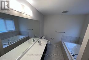 Niagara Falls (Brown) apartment for rent - A bathroom with a tub, sink, and toilet.
