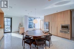Mississauga (City Centre) condo for rent - A modern dining room with a wooden table and chairs.
