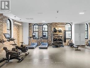 Toronto (Church-Yonge Corridor) condo for rent - A gym with a brick wall and exercise equipment.