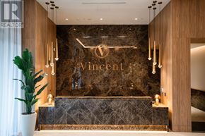 Vaughan (Vaughan Corporate Centre) condo for rent - A reception area with a large Vincent logo on the wall.