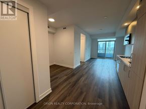 Vaughan (Vaughan Corporate Centre) condo for rent - A spacious room with wood flooring and white walls.