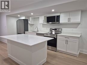 Hamilton apartment for rent - A modern kitchen with white cabinets and stainless steel appliances.