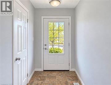 Kitchener townhouse for rent - A white door with a glass window is in a room with a tiled floor.