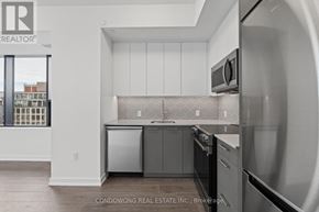 Kitchener condo for rent - A modern kitchen with white cabinets and stainless steel appliances.