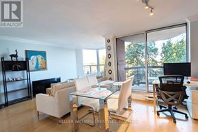 London East (East F) condo for rent - A living room with a glass table and chairs.