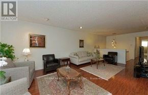 Toronto (Hillcrest Village) apartment for rent - A living room with a grey couch, a black chair, a coffee table, and a painting on the wall.