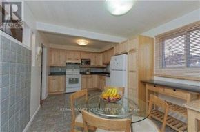 Toronto (Hillcrest Village) apartment for rent - A kitchen with a table and chairs and a bowl of bananas on the table.