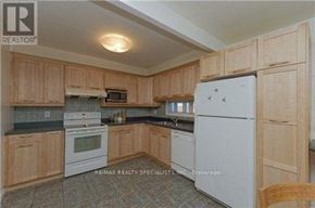 Toronto (Hillcrest Village) apartment for rent - A kitchen with wooden cabinets and white appliances.