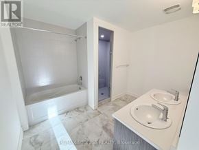 Barrie apartment for rent - A white bathroom with a marble floor and a walk-in shower.