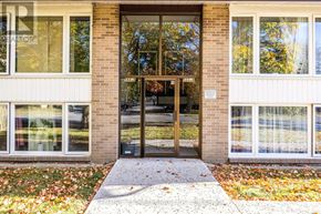 Brampton (Downtown Brampton) fourplex for rent - A building entrance with a glass door and a sign above it.